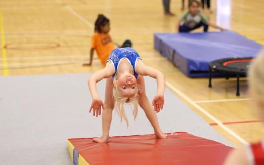 a girl doing a plank on a mat