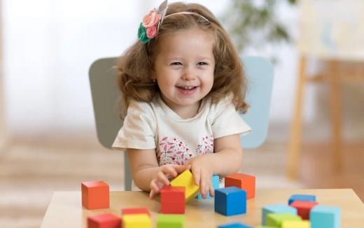 a girl playing with blocks