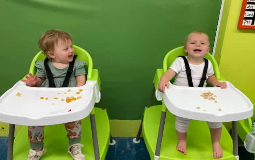 two children sitting in chairs