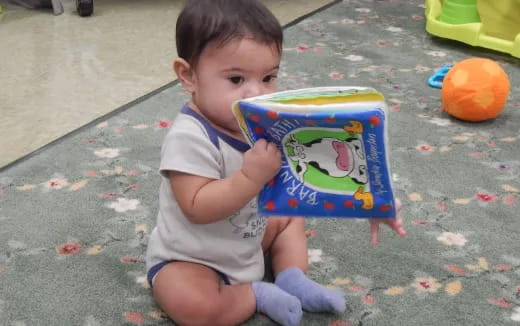 a baby holding a book