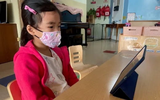 a young girl using a tablet