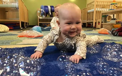 a baby crawling on a blue blanket