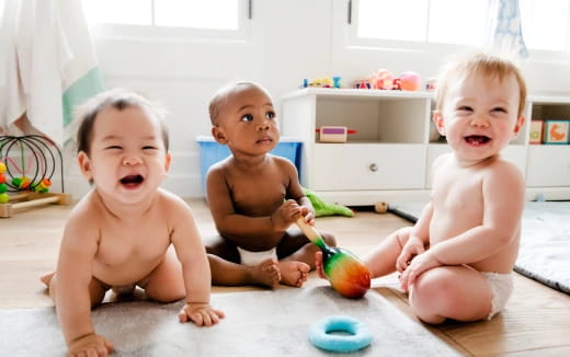 a group of babies sitting on the floor