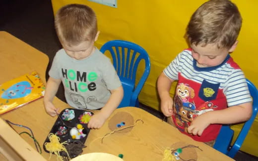 two boys sitting at a table