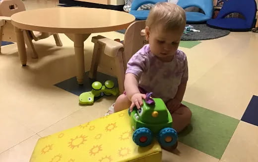 a baby playing with toys