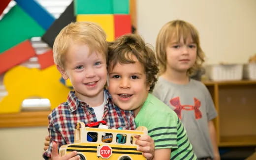 a group of children holding a toy