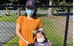 a person and a child wearing a mask