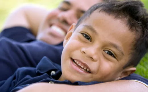 a boy smiling with his eyes wide open