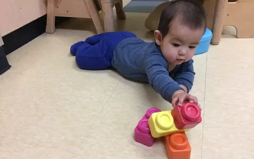 a baby playing with a toy