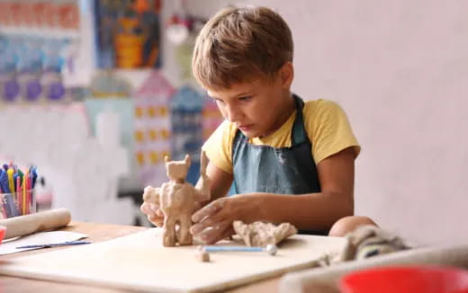 a young boy sitting at a desk