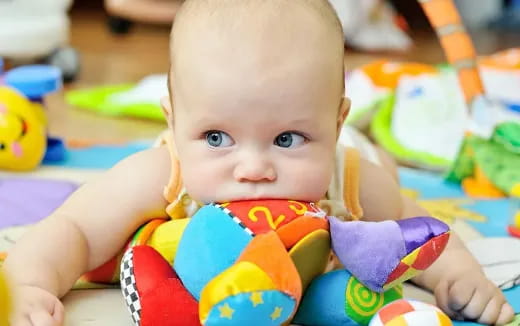 a baby lying on a blanket