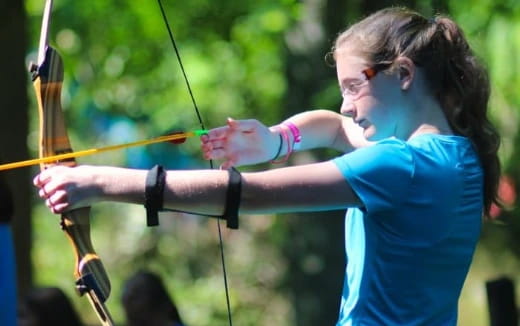 a woman shooting a bow