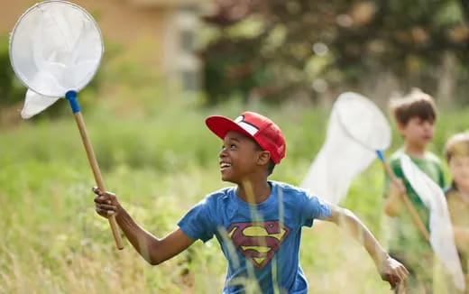 a boy holding a white object