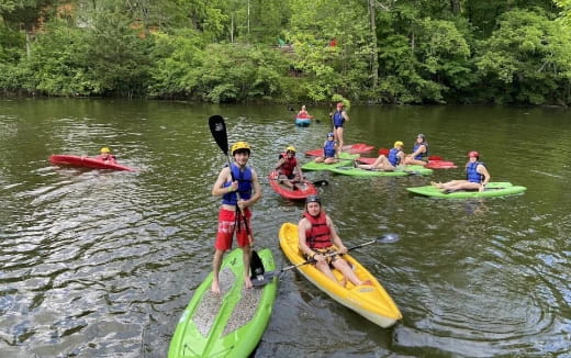 a group of people in kayaks on a river