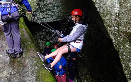 a group of people climbing a rock