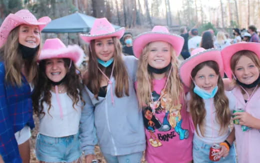 a group of girls wearing pink hats
