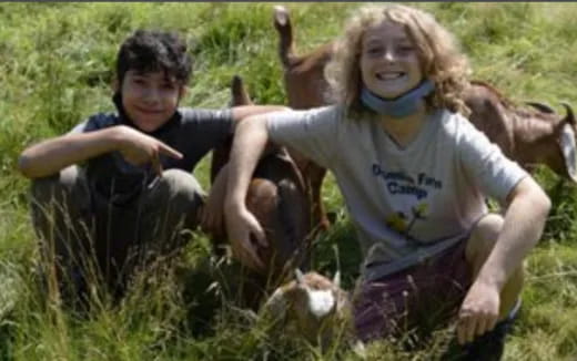 a boy and girl in a field