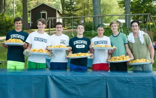 a group of people holding plates of food