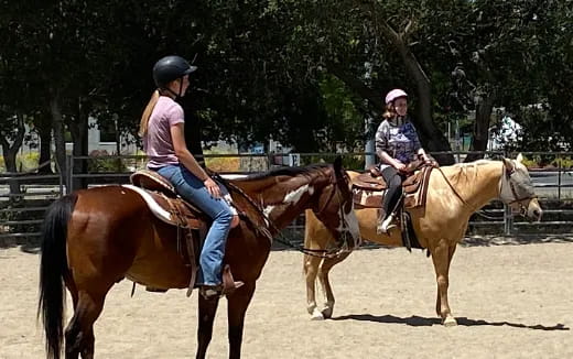 two women riding horses