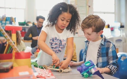 a person and a boy playing with toys