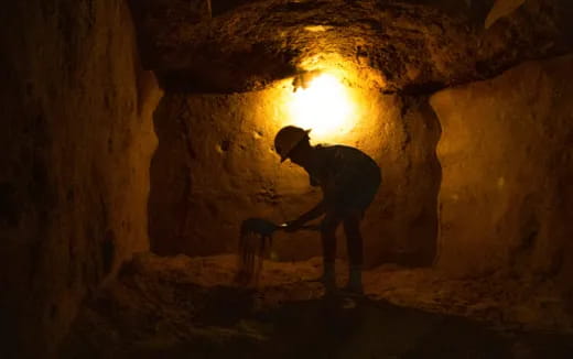 a person working in a cave