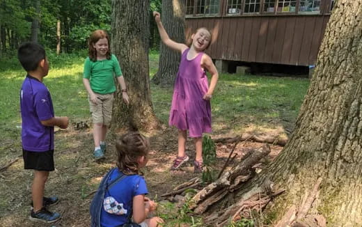 a group of children playing in the woods