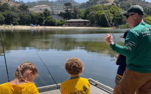 a man and two boys fishing