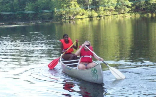 a couple of people rowing a boat