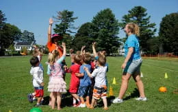 a group of children playing in a field