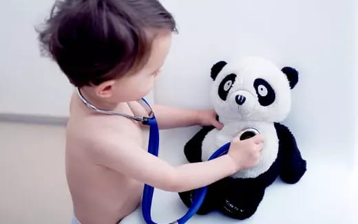 a baby holding a stuffed panda