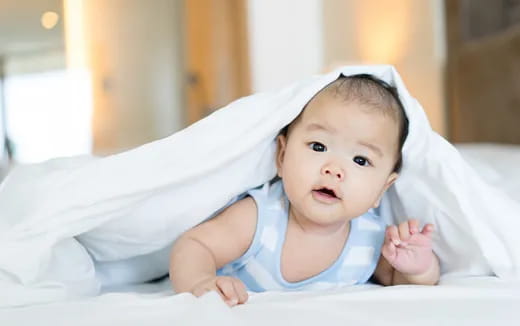 a baby lying on a bed