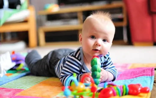 a baby lying on the floor