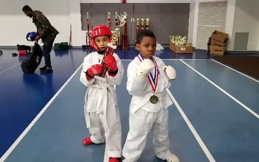a boy and a girl in white karate uniforms
