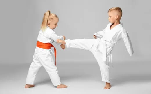 a boy and girl in karate uniforms