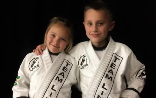 a boy and girl wearing football jerseys