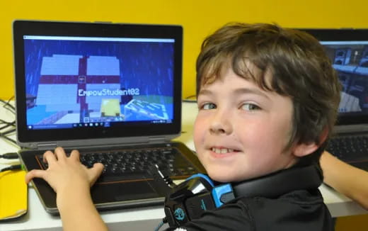 a boy holding a laptop