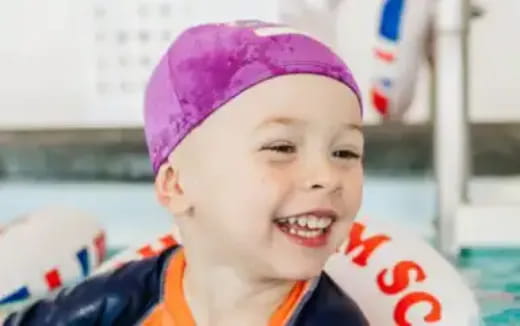 a child wearing a pink hat