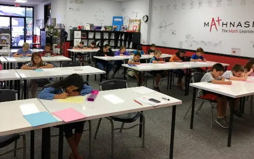 a classroom with desks and children