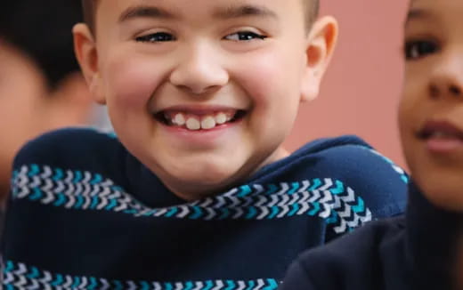 a close-up of a boy smiling