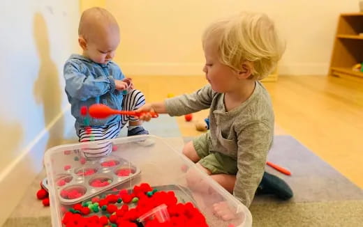 a couple of babies playing with toys