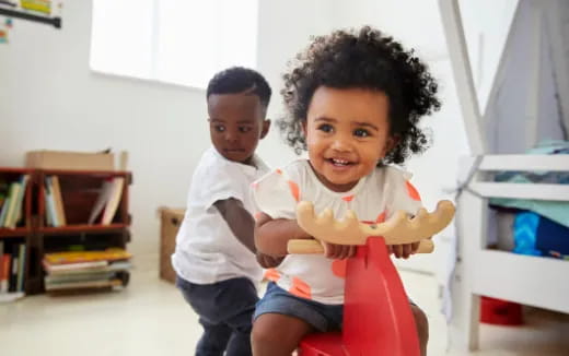 a couple of children holding a baby