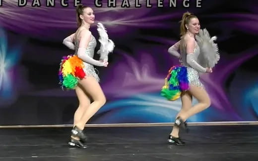 a couple of women dancing on a stage