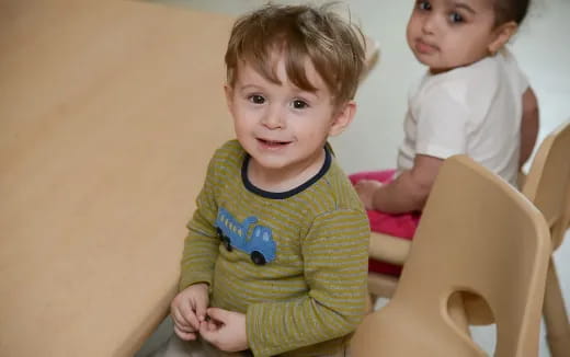 a couple of young boys sitting in chairs