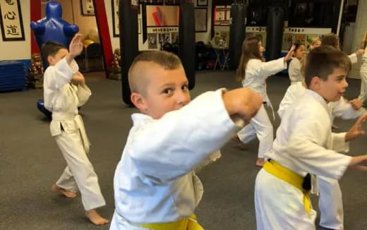 a group of children in karate uniforms