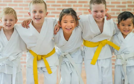 a group of children in karate uniforms