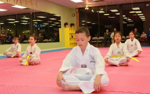 a group of children in karate uniforms