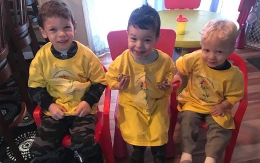 a group of children sitting in chairs