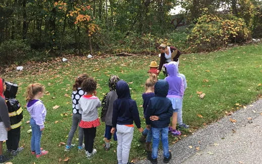 a group of children standing on a path in a park