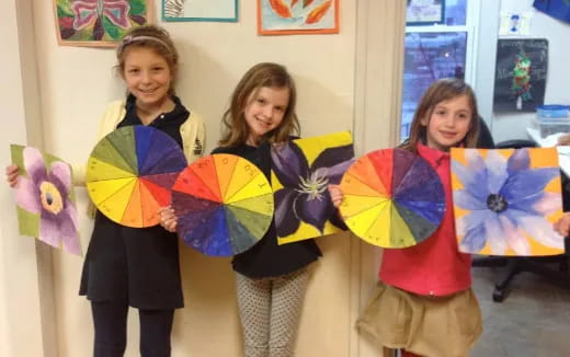 a group of girls holding kites