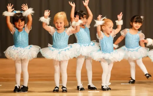 a group of girls in blue dresses